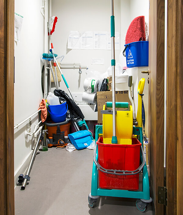 Janitorial supplies stacked up in an office cupboard